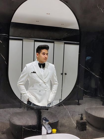 Ready for the event in our white double-breasted tuxedo. The modern silhouette and perfect fit make it an excellent choice for any formal celebration.
