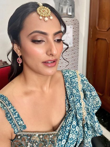 A lovely, soft look for a Mehendi ceremony. The makeup is minimal and fresh, with a focus on clean skin and a hint of color on the lips.