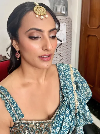 A lovely, soft look for a Mehendi ceremony. The makeup is minimal and fresh, with a focus on clean skin and a hint of color on the lips.