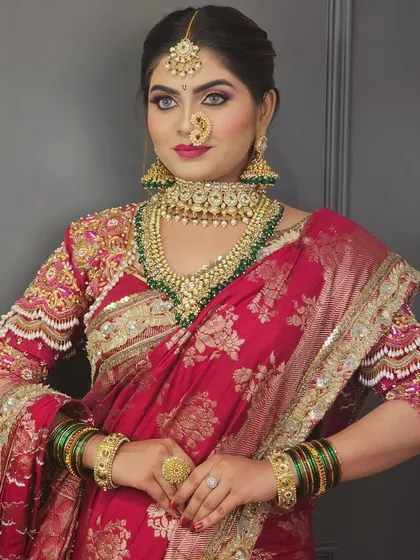 A full view of the Marathi bride, showcasing her complete look with the intricate saree and heavy jewelry.