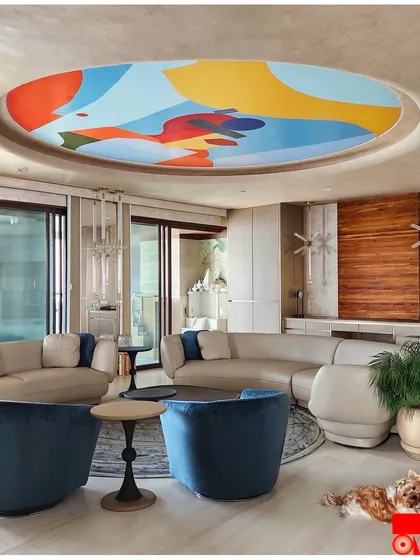 The fifth wall is my canvas. For this Mumbai home, I created a 14-foot abstract depiction of the city on the ceiling, turning the living room's sky into a vibrant ode to "Mumbai meri jaan".