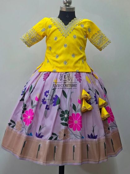 A beautiful floral lehenga in lavender and yellow. The blouse has delicate silver embroidery.