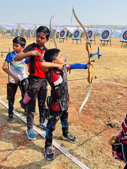 Even our youngest archers learn discipline and focus. Here, a young boy gets ready on the shooting line at a state competition, showing the confidence that comes from our structured training programs.