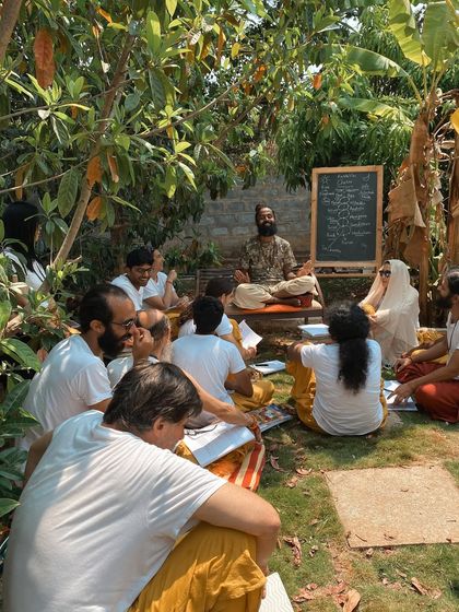 An outdoor philosophy class under the banyan tree. I believe in teaching in a way that is alive and connected to our surroundings. Here, I explain that yoga is the study of "you" to realize you are not just "you."