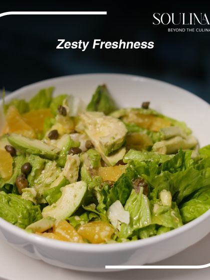 A zesty and fresh salad featuring avocado, orange segments, and capers. A perfect example of our light, flavourful, and healthy creations.