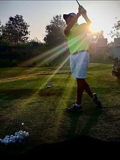 A perfect silhouette of a golfer practicing during sunset. This is what living your best life on the course looks like.