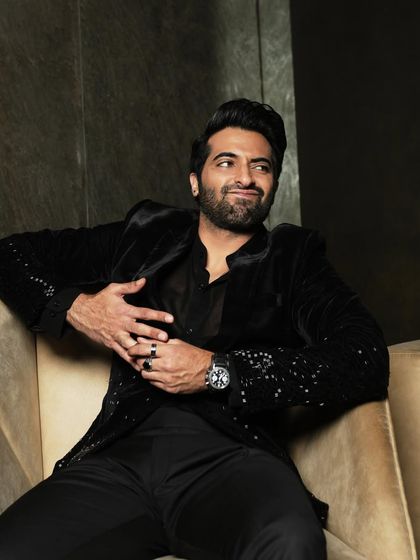 A playful and engaging seated portrait, showcasing the actor's personality.