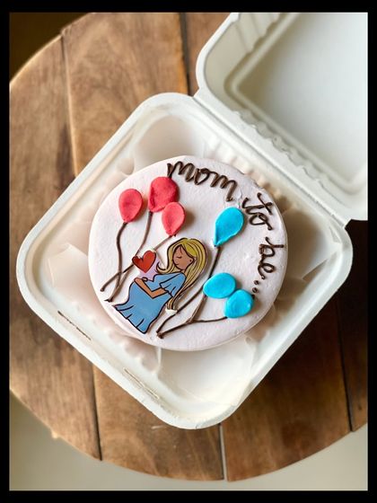 A sweet cake for a mom-to-be, featuring a lovely illustration of an expecting mother holding her belly, surrounded by pink and blue balloons. It's perfect for a baby shower or gender reveal.