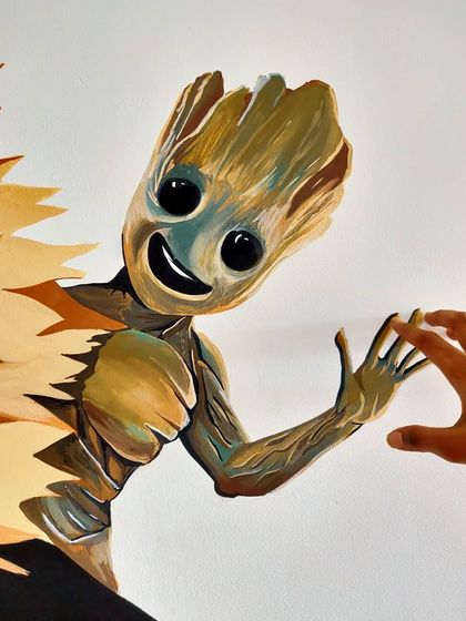We love making our art interactive. This close up shows how we painted Groot to look like he's reaching out for a high five.
