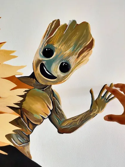 We love making our art interactive. This close up shows how we painted Groot to look like he's reaching out for a high five.