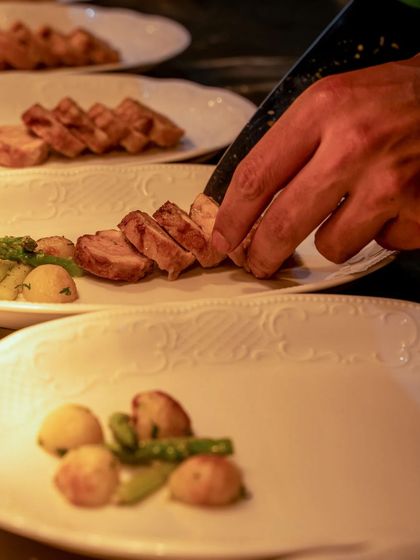 A close-up of the plating process, showing the careful arrangement of each element.