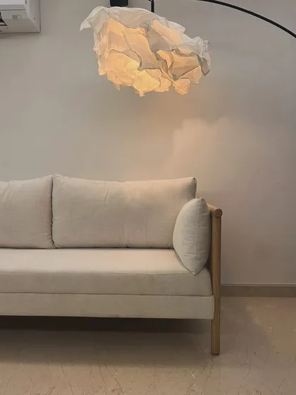 Detail shot of the armrest and cane panel on the oak sofa.