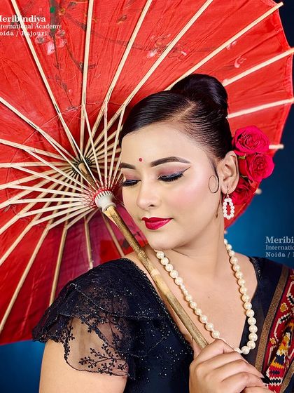 Using props like this red umbrella enhances the vintage theme. This shows how to create a full concept for a photoshoot.