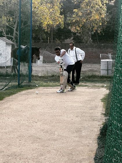 A fellow advocate watches on during my batting practice. We prepare for every eventuality, both in court and on the field.