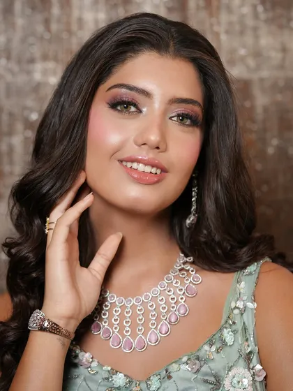 A beautiful smile is the best accessory. This close-up shot showcases her radiant skin and the soft, glamorous eye makeup that pairs perfectly with her pastel gown and diamond jewelry.
