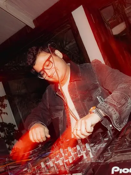 A motion-blur shot capturing the fast-paced energy of mixing tracks during a packed wedding party.