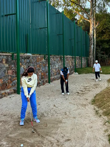 A group of golfers works on their bunker shots, a crucial skill for lowering scores.