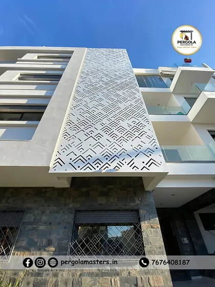 A large-scale architectural facade on a modern apartment building, featuring a custom geometric pattern created with precision laser cutting. This demonstrates our capability to execute complex, large-format metalwork for commercial and multi-unit residential projects.