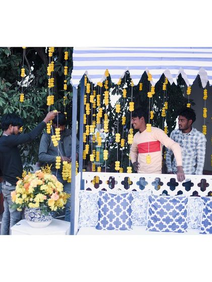 Behind the scenes at the blue and yellow Haldi, with our team setting up the marigold strings. It's the hard work of these artists that brings every vision to life.