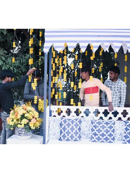 Behind the scenes at the blue and yellow Haldi, with our team setting up the marigold strings. It's the hard work of these artists that brings every vision to life.