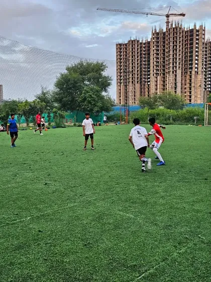 A player watches intently as his teammate challenges an opponent for the ball. Action speaks louder than the coach.