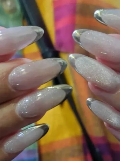 A close-up of the silver glitter French manicure, showing the density of the glitter for maximum impact.