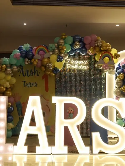 A straight-on shot of Arsh's birthday stage, with the large, illuminated marquee letters taking center stage.