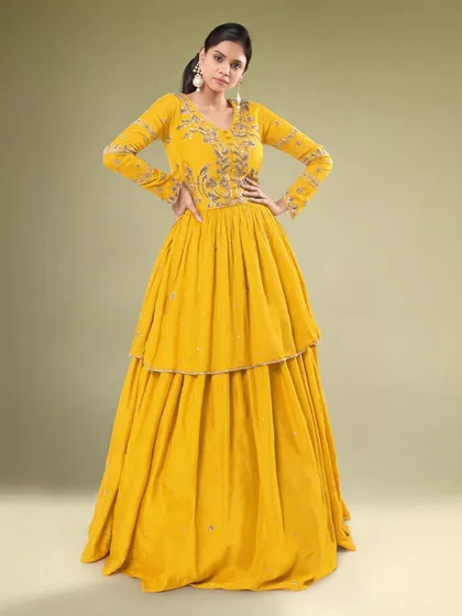 A full look at the yellow tiered Indo-western outfit. The layered skirt adds a fun and modern element to the traditional silhouette.