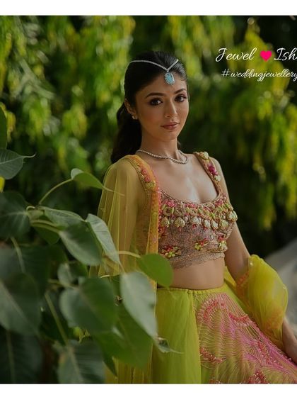 A vibrant and modern Mehendi look. This bride pairs a neon green and pink lehenga with our minimal diamond necklace and a statement turquoise sheeshpatti for a look that is fun, fresh, and totally unique.
