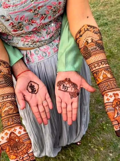 We specialize in highly detailed bridal mehndi that tells a story. This design features intricate figures of a bride and groom, a doli scene, and a Ganesh motif for blessings, all created with our 100% natural henna paste.