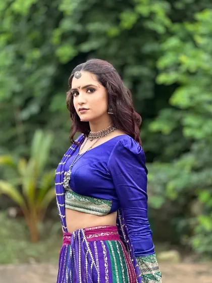A side profile of the royal blue Navratri look. The makeup is blended seamlessly to match the festive vibes of her colorful outfit.