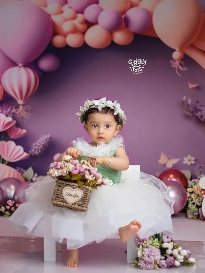 A perfect portrait of a birthday girl in her floral wonderland, holding a basket of flowers and ready to celebrate.