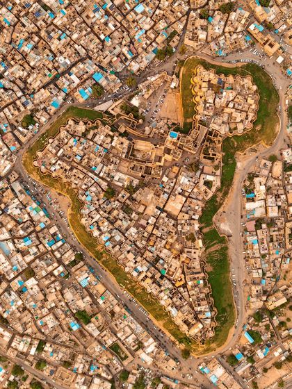 A top-down view of an ancient walled city, where the layout of the streets and buildings forms the shape of a "Flat frog." This is about finding patterns and stories in the landscape.