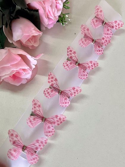 For a fun and flirty vibe, these pink polka-dotted butterflies are the perfect choice.