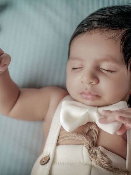 A close-up shot focusing on the baby's peaceful expression and dapper outfit in our celestial theme. The details make these portraits truly special.