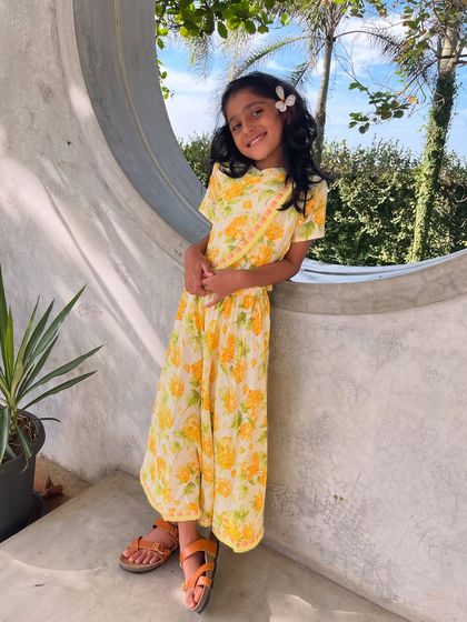 Another look at our sunny yellow floral chaniya choli. The lightweight cotton and cheerful print make it a favorite for both moms and kids.