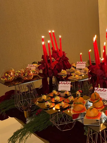 A close-up of the Christmas-themed appetizer table, featuring our Baked Vada Pav Bao and other festive bites.