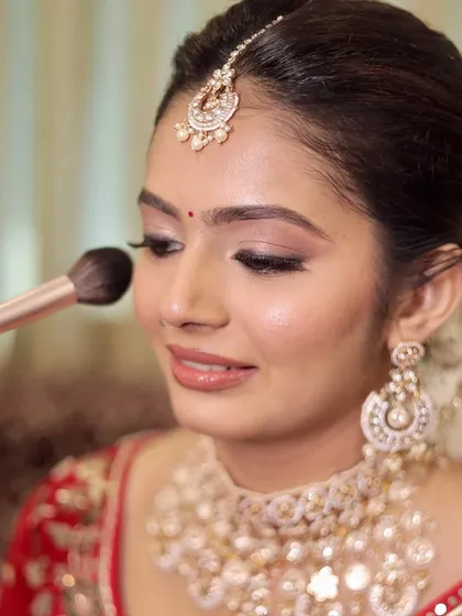 A detailed shot of my skin-focused makeup application. Using a soft brush, I ensure the foundation and blush are seamlessly blended, creating a natural finish that looks like real skin, just better.