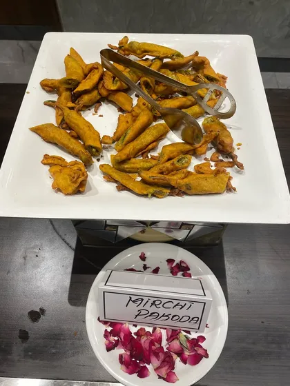 Mirchi Pakoda, large green chilies stuffed with a savory filling and fried, for those who like it spicy.