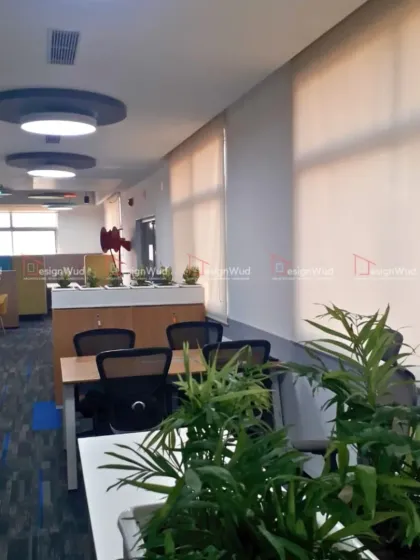 We incorporate biophilic design elements like indoor plants to improve air quality and create a more pleasant work environment. This image shows planters placed strategically between workstation clusters, breaking the monotony and adding a natural touch.