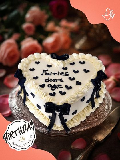 A delicate heart-shaped cake with the message "Fairies don't age." This whimsical and charming design is perfect for someone who is young at heart.
