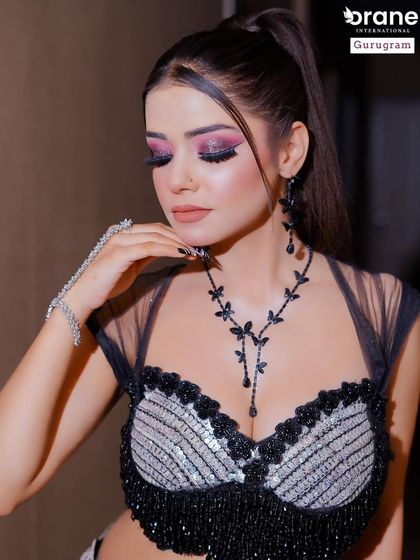 A full view of the dramatic black and silver outfit, complemented by bold pink and black eye makeup. I teach students how to create a balanced look even with contrasting colors.