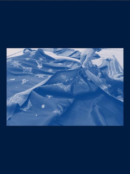 The deep blue of a cyanotype print can be incredibly rich and immersive. This piece focuses on the folds and patterns of fabric, creating a captivating abstract image.