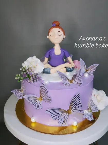 A serene yoga-themed cake with a meditating figurine, perfect for a yoga enthusiast.