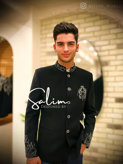 A client in a black Bandhgala jacket with delicate silver embroidery on the collar, cuffs, and chest. It's an example of understated elegance perfect for a formal event.