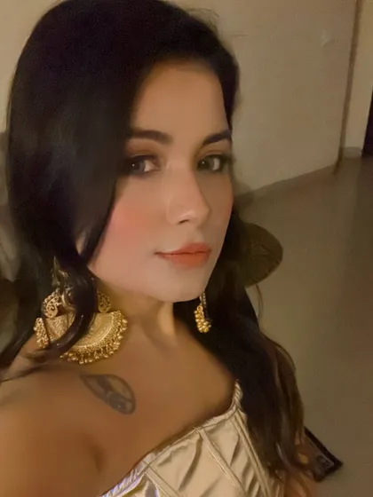 Another look at these stunning oversized gold-tone earrings. This selfie shows how they catch the light and add a festive, glamorous touch even with a simple, elegant outfit.