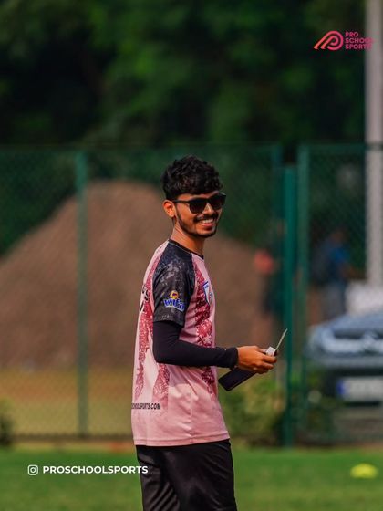 Just good vibes on the field. A coach enjoying the session with a smile.