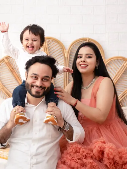 The pure bliss of family. Moments like this, with a child held high and surrounded by love, are what we will freeze in time together. This is more than a photo; it's the feeling of home.