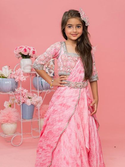 Our pink tie dye saree is perfect for a festive daytime event, paired here with a floral backdrop.