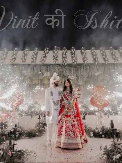 A grand entrance deserves a grand photograph. We positioned the couple at the center of this magnificent wedding venue, using the sparklers and decor to frame them and capture the epic scale of their celebration.